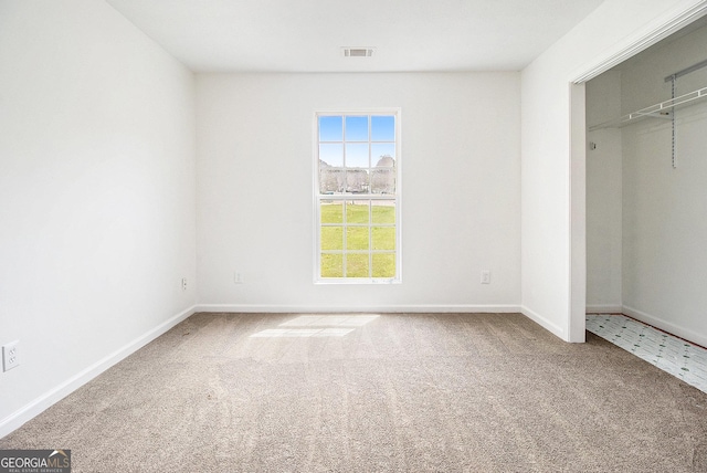unfurnished bedroom featuring carpet floors, baseboards, and a closet