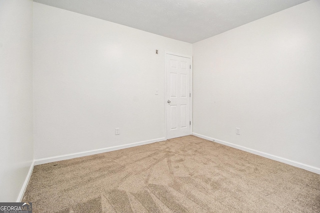 empty room with carpet floors and baseboards