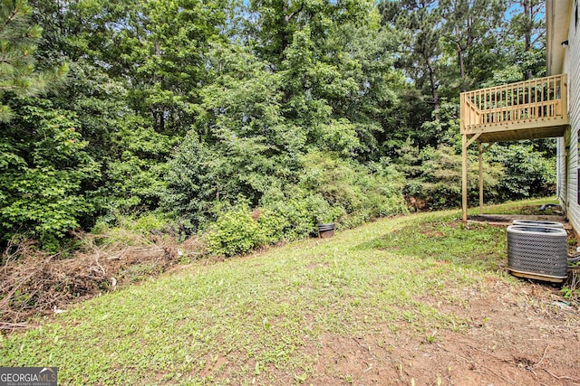 view of yard featuring cooling unit and a wooden deck