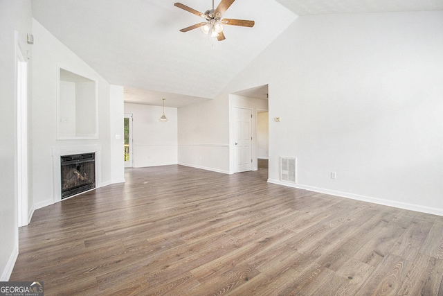 unfurnished living room with a ceiling fan, high vaulted ceiling, wood finished floors, a fireplace, and baseboards