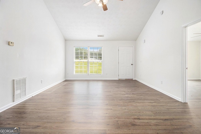 unfurnished living room with a ceiling fan, vaulted ceiling, wood finished floors, and baseboards