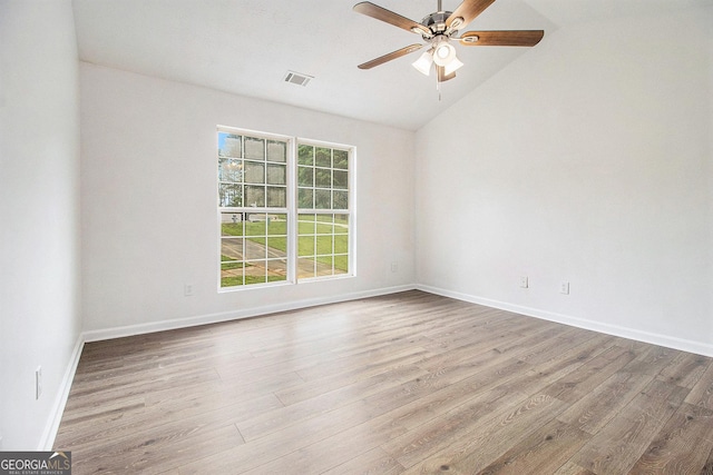 unfurnished room featuring vaulted ceiling, ceiling fan, wood finished floors, and baseboards