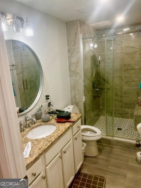 3629 Centerview Dr, Marietta, GA 30066 - full bathroom with toilet, a stall shower, vanity, and wood finished floors