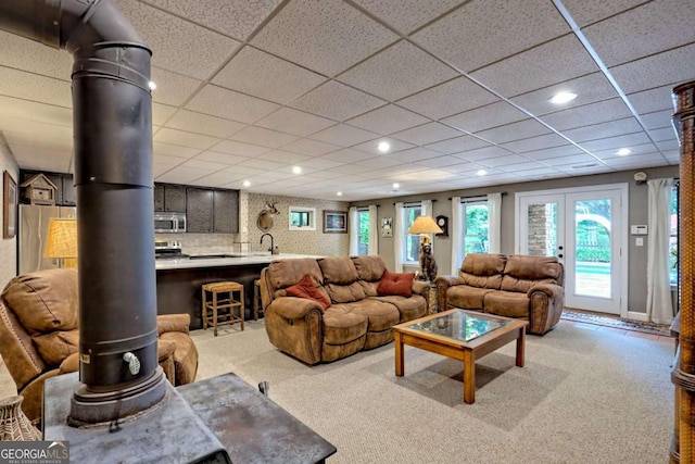 2877 Cynth Creek Rd, Hiawassee, GA 30546 - carpeted living area with recessed lighting, a wood stove, a sink, and a drop ceiling
