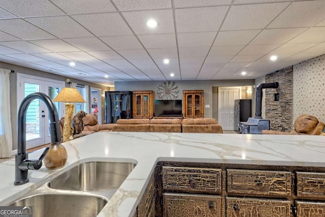 2877 Cynth Creek Rd, Hiawassee, GA 30546 - kitchen with a sink, a wood stove, open floor plan, light stone countertops, and recessed lighting