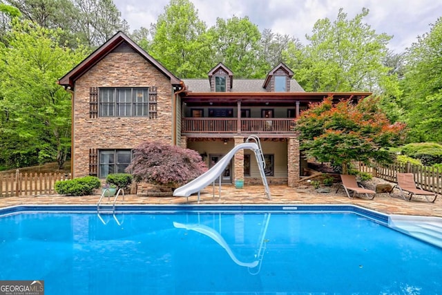 2877 Cynth Creek Rd, Hiawassee, GA 30546 - view of swimming pool with a water slide, a patio area, and view of wooded area