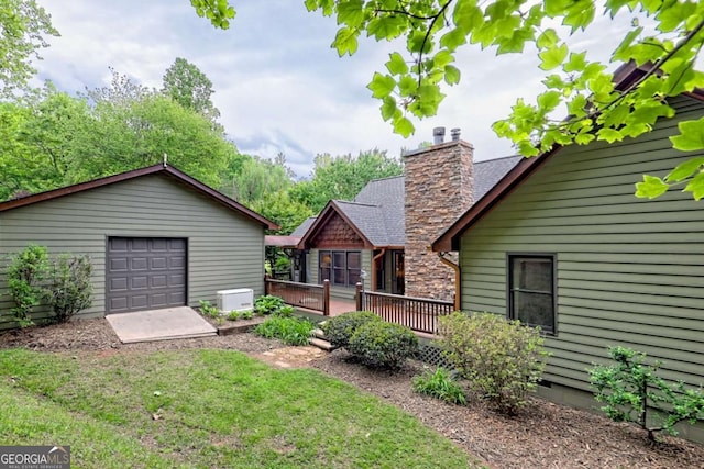 2877 Cynth Creek Rd, Hiawassee, GA 30546 - rear view of house with a deck, an outbuilding, a chimney, a garage, and a lawn