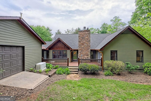 2877 Cynth Creek Rd, Hiawassee, GA 30546 - back of property with a chimney, a garage, a lawn, and roof with shingles