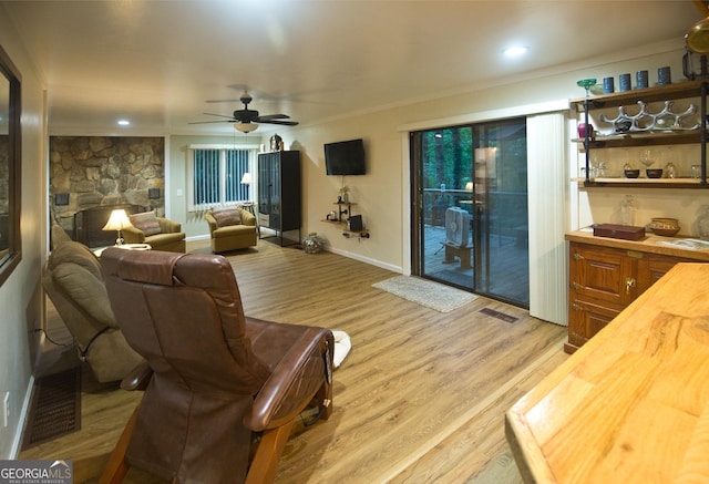 407 Hillside Dr, Clayton, GA 30525 - living area featuring light wood-type flooring, a ceiling fan, baseboards, a fireplace, and crown molding