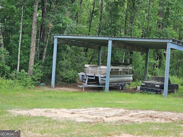 536 Gov Seay Rd, Collins, GA 30421 - view of yard featuring a detached carport and a wooded view