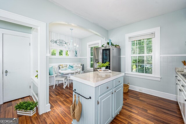 1101 Cherokee Dr, Waycross, GA 31501 - kitchen featuring light countertops, arched walkways, and dark wood finished floors