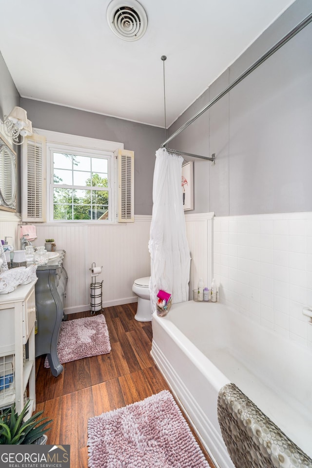 1101 Cherokee Dr, Waycross, GA 31501 - bathroom featuring wood finished floors, toilet, wainscoting, and vanity