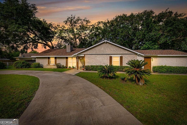 503 Marsh Cir, Saint Simons, GA 31522 - view of front of house featuring a front yard, a chimney, and concrete driveway