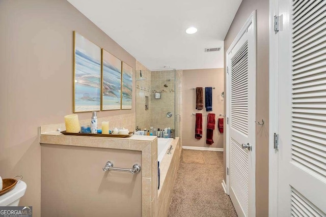503 Marsh Cir, Saint Simons, GA 31522 - bathroom featuring tiled shower, a tub to relax in, and recessed lighting