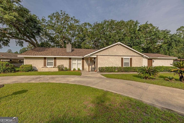 503 Marsh Cir, Saint Simons, GA 31522 - ranch-style home with a front lawn and a chimney