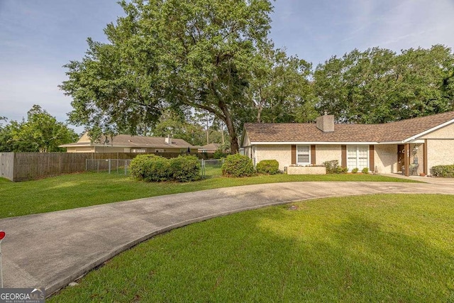 503 Marsh Cir, Saint Simons, GA 31522 - view of front of home featuring a chimney, concrete driveway, and stucco siding