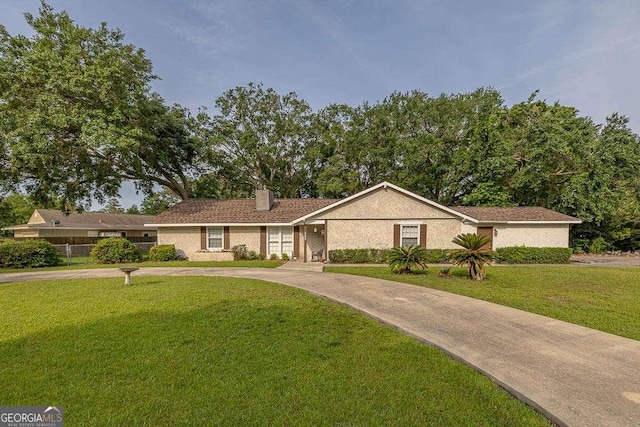 503 Marsh Cir, Saint Simons, GA 31522 - ranch-style house with a front yard and a chimney