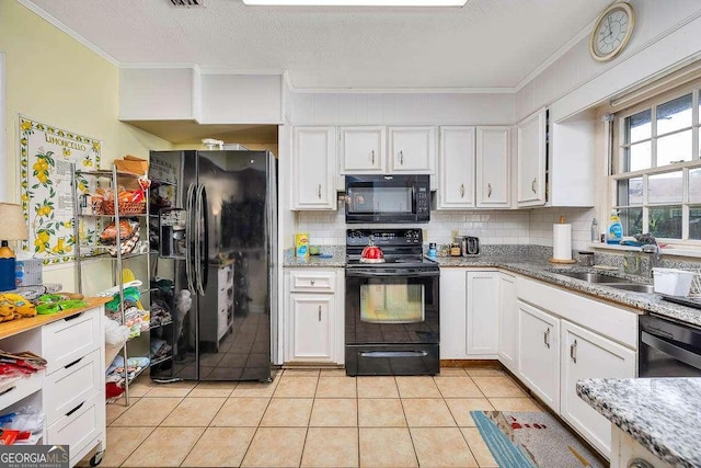 503 Marsh Cir, Saint Simons, GA 31522 - kitchen with black appliances, crown molding, a sink, white cabinets, and a textured ceiling