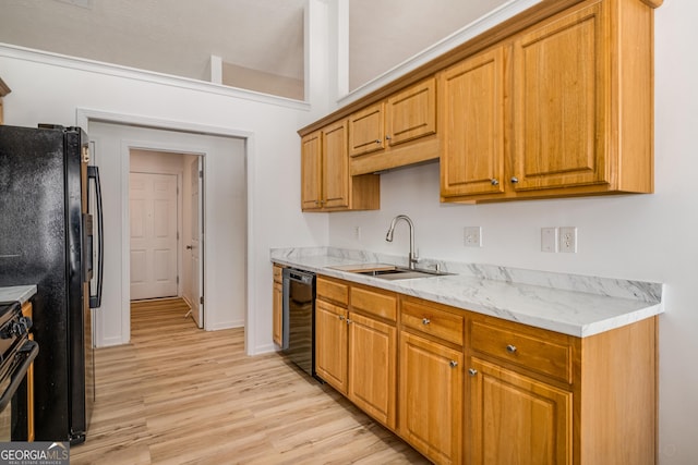 14 Winter Ln, Newnan, GA 30265 - kitchen featuring a sink, black appliances, light wood-style flooring, brown cabinets, and baseboards