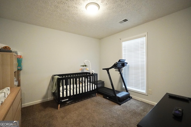 bedroom featuring a textured ceiling, multiple windows, carpet flooring, and baseboards