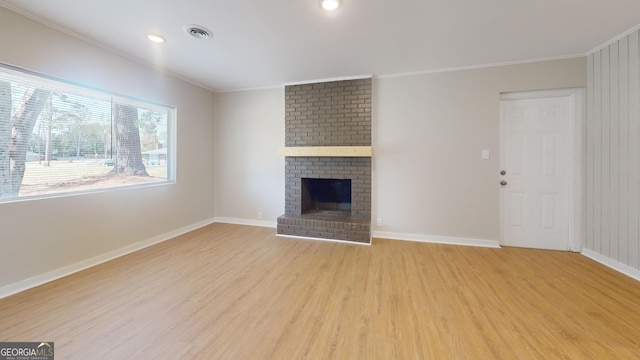 2280 Raleigh Dr, Augusta, GA 30904 - unfurnished living room featuring light wood finished floors, ornamental molding, baseboards, a brick fireplace, and recessed lighting
