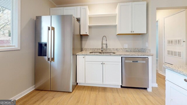 2280 Raleigh Dr, Augusta, GA 30904 - kitchen featuring stainless steel appliances, a sink, light wood finished floors, baseboards, and open shelves