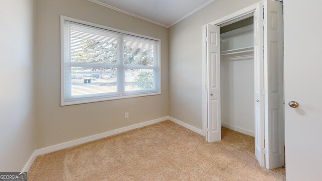 2280 Raleigh Dr, Augusta, GA 30904 - unfurnished bedroom featuring light carpet, crown molding, a closet, and baseboards