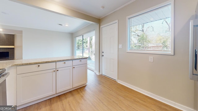 2280 Raleigh Dr, Augusta, GA 30904 - kitchen featuring light wood-type flooring, baseboards, crown molding, white cabinets, and light stone countertops