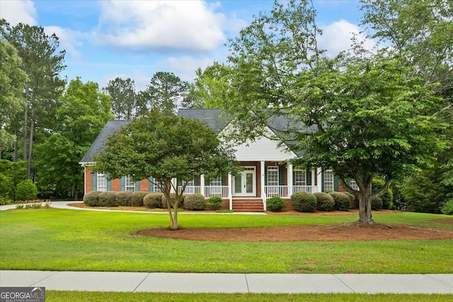 1253 Oakwood Pl, Loganville, GA 30052 - view of front of property with a porch, a front lawn, french doors, and brick siding