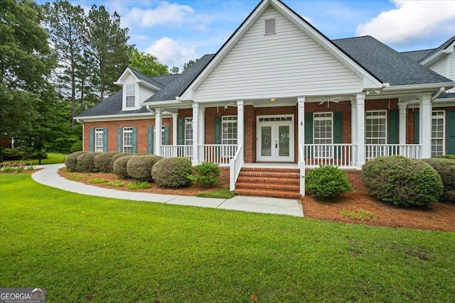 1253 Oakwood Pl, Loganville, GA 30052 - view of front of house with brick siding, a front yard, a porch, roof with shingles, and french doors