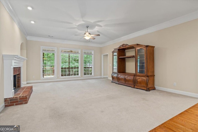 1253 Oakwood Pl, Loganville, GA 30052 - unfurnished living room with ceiling fan, ornamental molding, baseboards, a fireplace, and light colored carpet