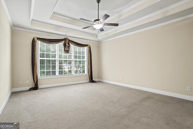 1253 Oakwood Pl, Loganville, GA 30052 - carpeted empty room featuring a raised ceiling, crown molding, ceiling fan, and baseboards