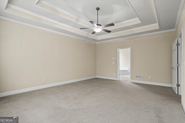 1253 Oakwood Pl, Loganville, GA 30052 - carpeted empty room with a tray ceiling, ceiling fan, ornamental molding, and baseboards