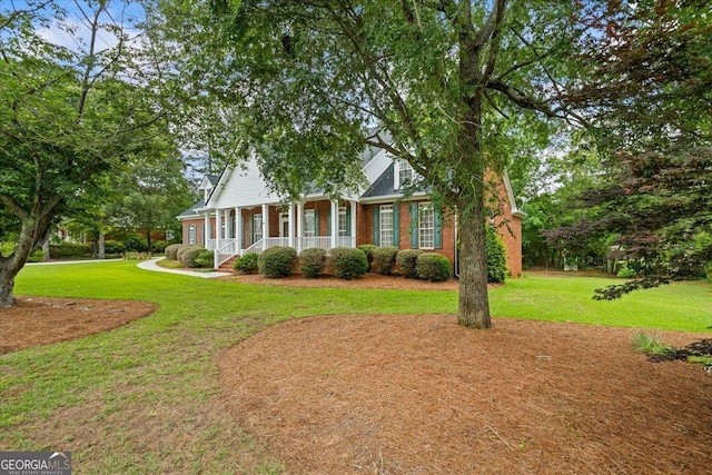 1253 Oakwood Pl, Loganville, GA 30052 - view of front facade with a porch, brick siding, and a front yard