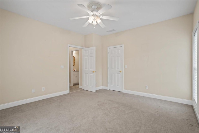1253 Oakwood Pl, Loganville, GA 30052 - unfurnished bedroom with carpet flooring, baseboards, and ceiling fan