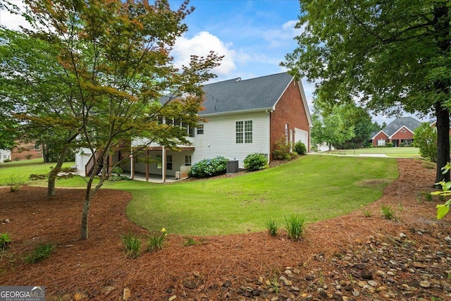1253 Oakwood Pl, Loganville, GA 30052 - rear view of house featuring a lawn, roof with shingles, and a patio