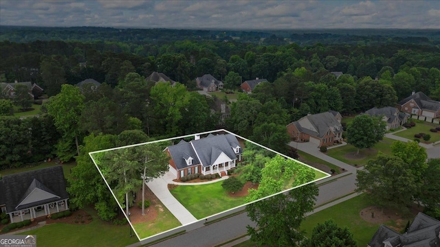 1253 Oakwood Pl, Loganville, GA 30052 - aerial perspective of suburban area featuring a forest and property boundaries highlighted