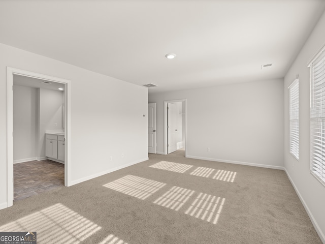 carpeted empty room with baseboards