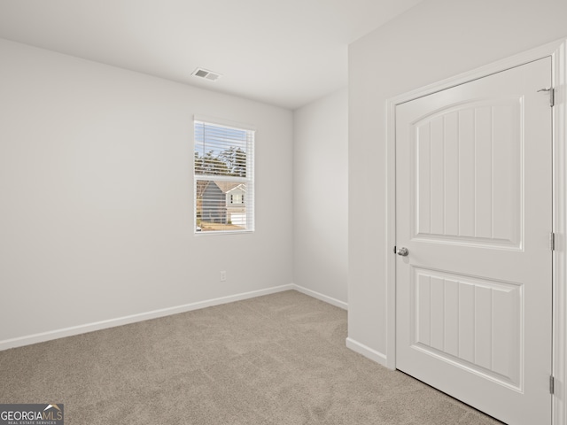empty room with carpet and baseboards