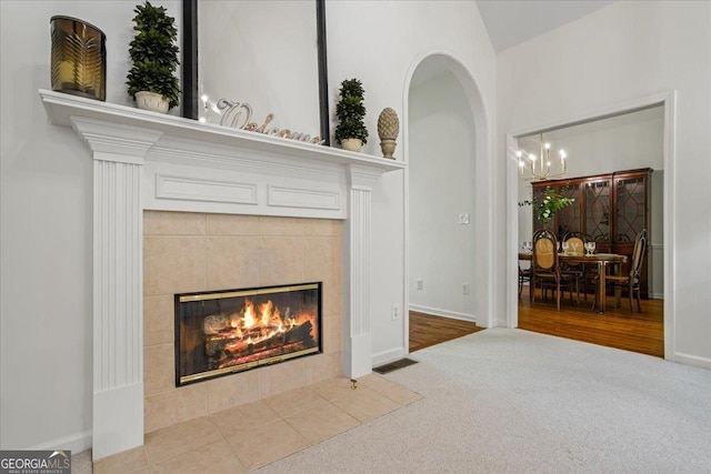1444 Merrifield Ln, Marietta, GA 30062 - detailed view of a chandelier, carpet flooring, a fireplace, arched walkways, and baseboards