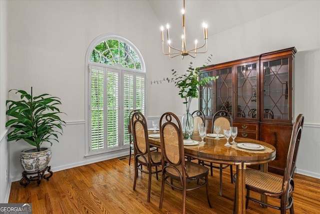 1444 Merrifield Ln, Marietta, GA 30062 - dining space with a chandelier, wood finished floors, and high vaulted ceiling