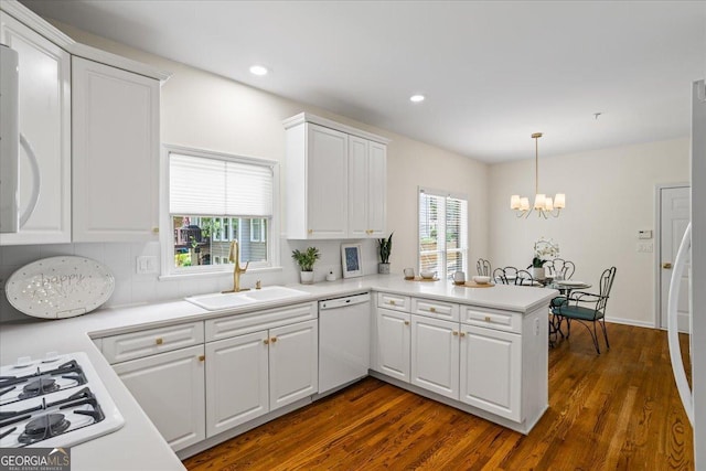 1444 Merrifield Ln, Marietta, GA 30062 - kitchen with white appliances, a sink, a chandelier, a peninsula, and white cabinetry