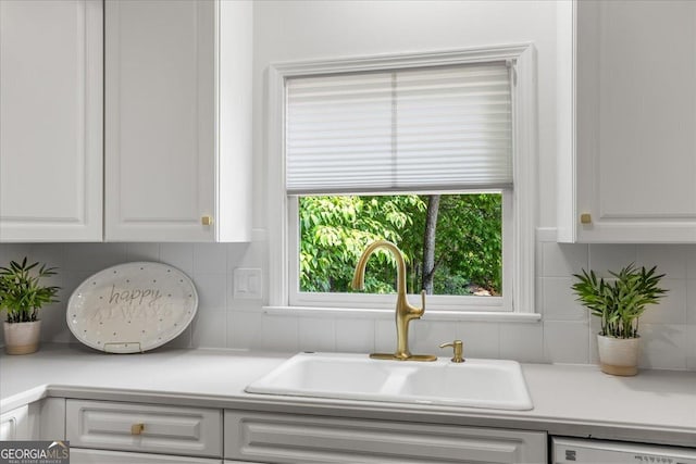 1444 Merrifield Ln, Marietta, GA 30062 - kitchen featuring a sink, white cabinets, light countertops, decorative backsplash, and dishwasher