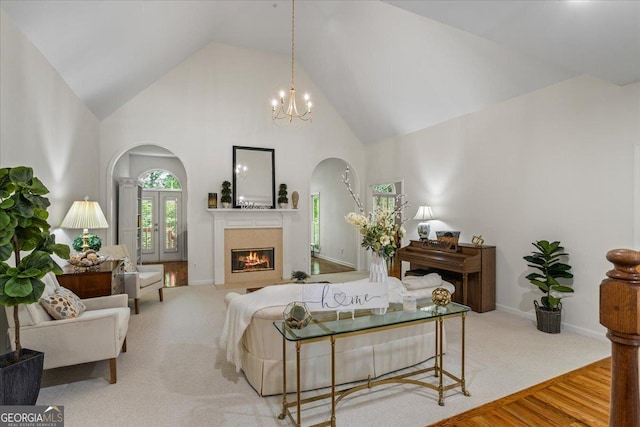 1444 Merrifield Ln, Marietta, GA 30062 - living room with arched walkways, high vaulted ceiling, a tile fireplace, a chandelier, and baseboards