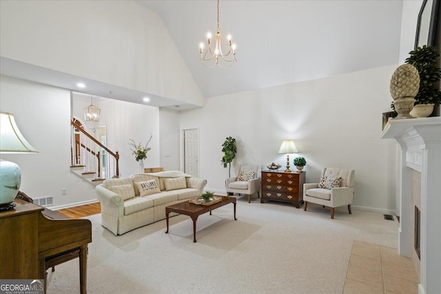 1444 Merrifield Ln, Marietta, GA 30062 - living area featuring a chandelier, stairway, high vaulted ceiling, carpet floors, and a fireplace with flush hearth