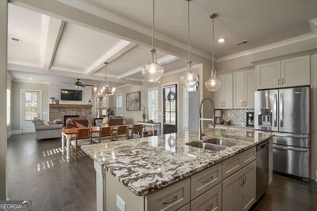 1325 Silo Bnd, Watkinsville, GA 30677 - kitchen featuring a sink, appliances with stainless steel finishes, a fireplace, tasteful backsplash, and dark wood-style flooring