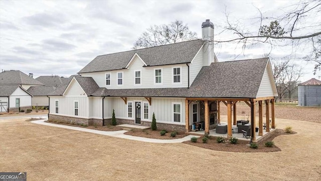 1325 Silo Bnd, Watkinsville, GA 30677 - modern farmhouse style home featuring a chimney, board and batten siding, a shingled roof, and a patio