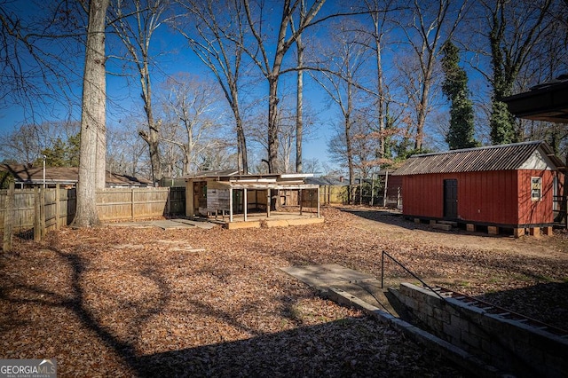 fenced backyard with an outbuilding