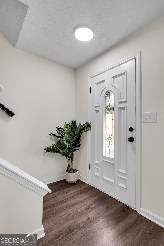 1075 Litchfield Way SW, Marietta, GA 30060 - entrance foyer featuring a textured ceiling, baseboards, and dark wood-style floors