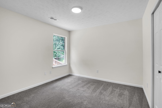 1075 Litchfield Way SW, Marietta, GA 30060 - empty room with a textured ceiling, baseboards, and dark carpet